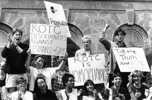 A group of protestors demonstrate in front of Bascom Hall during the weeks’ long protest of the ROTC’s anti-gay policy, ca. 1990. Protestors are holding signs that read “ROTC discriminates against Lesbians and Gays,” “ROTC is homophobic,” and “Tell the truth about ROTC Donna.”