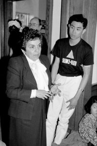 Donna Shalala stands outside her office next to a man wearing a T-shirt that reads “Silence=Death.”